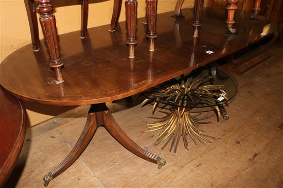 A Regency style banded mahogany D end extending two pillar dining table